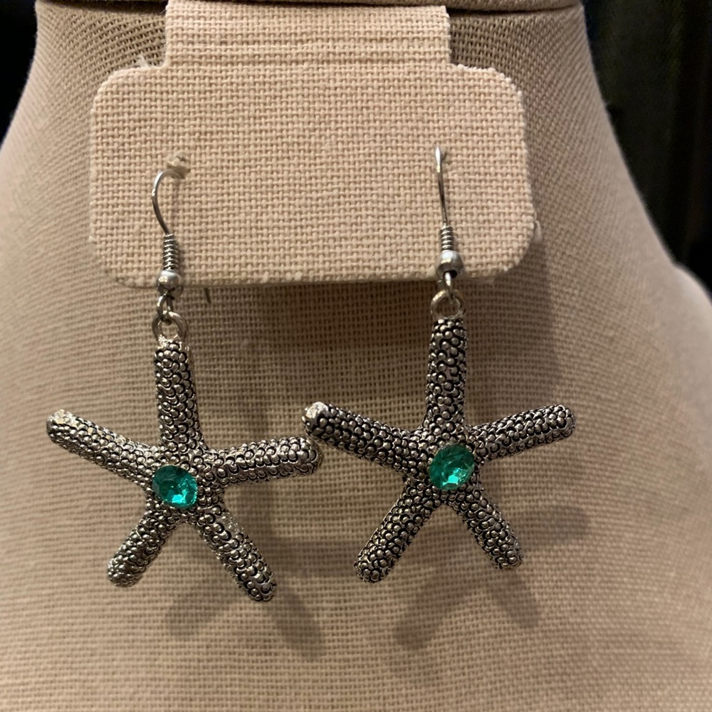 Silver toned starfish earrings with aquamarine colored stone